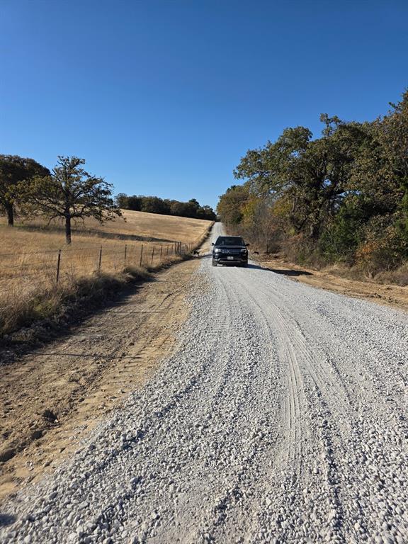 0 Holland Road Forestburg, TX 76239 - Photo 14 of 39 a view of dirt road with a building in the background