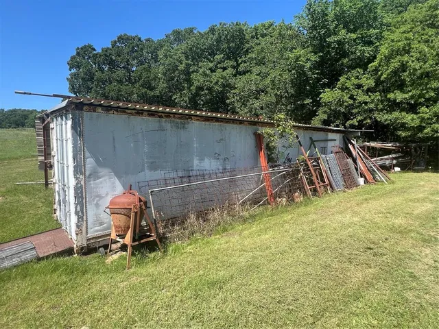 a view of a backyard with chairs and a grill