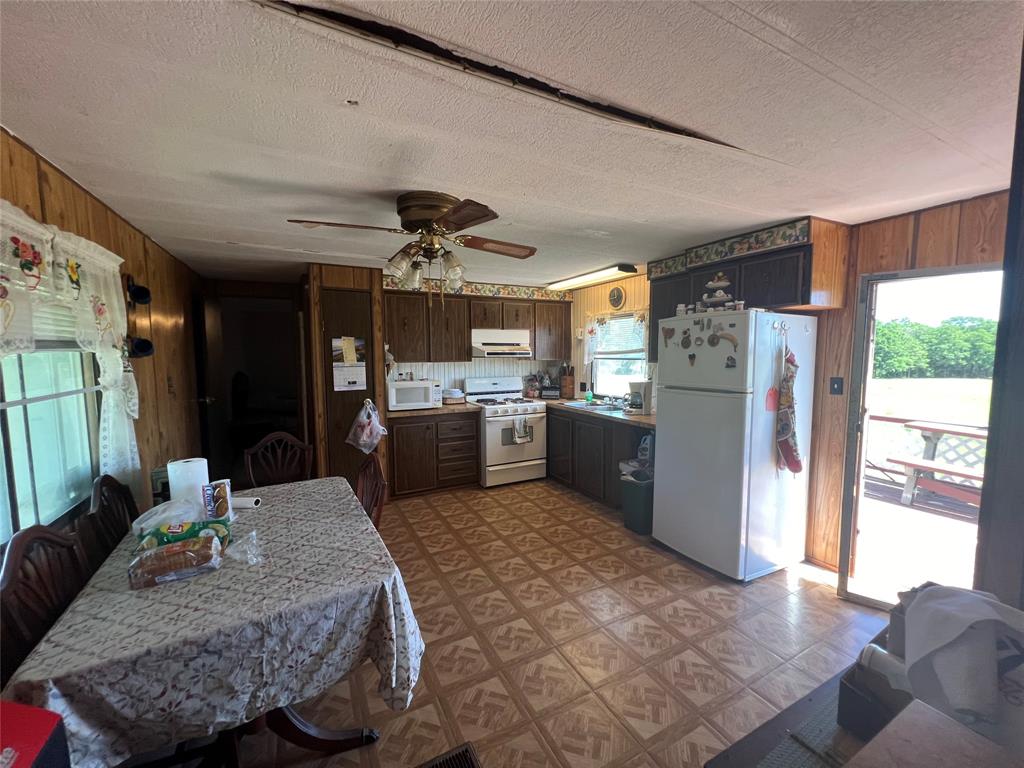 0 Holland Road Forestburg, TX 76239 - Photo 24 of 39 a living room with stainless steel appliances kitchen island granite countertop furniture and a kitchen view