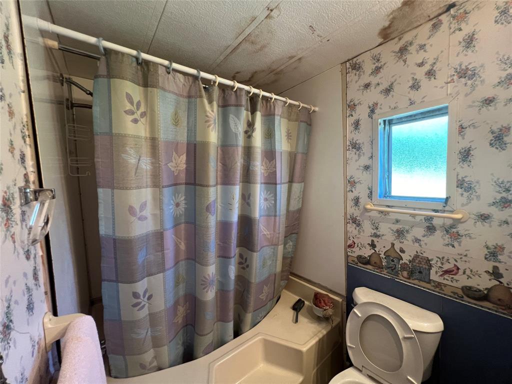 0 Holland Road Forestburg, TX 76239 - Photo 26 of 39 a bathroom with a sink toilet and shower