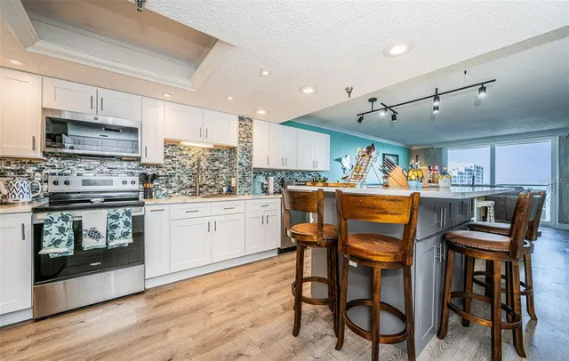 a front view of a building with streets and trees