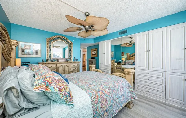 a bedroom with a bed a book shelf and a window