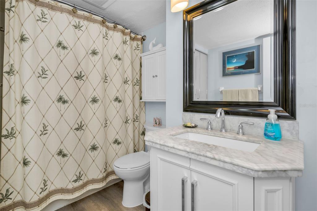 6035 Sea Ranch Drive, Unit 505 Hudson, FL 34667 - Photo 29 of 44 a bathroom with a granite countertop sink and a mirror