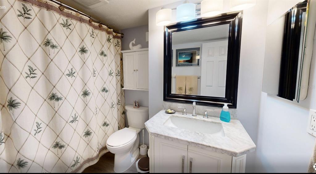 6035 Sea Ranch Drive, Unit 505 Hudson, FL 34667 - Photo 30 of 44 a bathroom with a granite countertop sink and a mirror