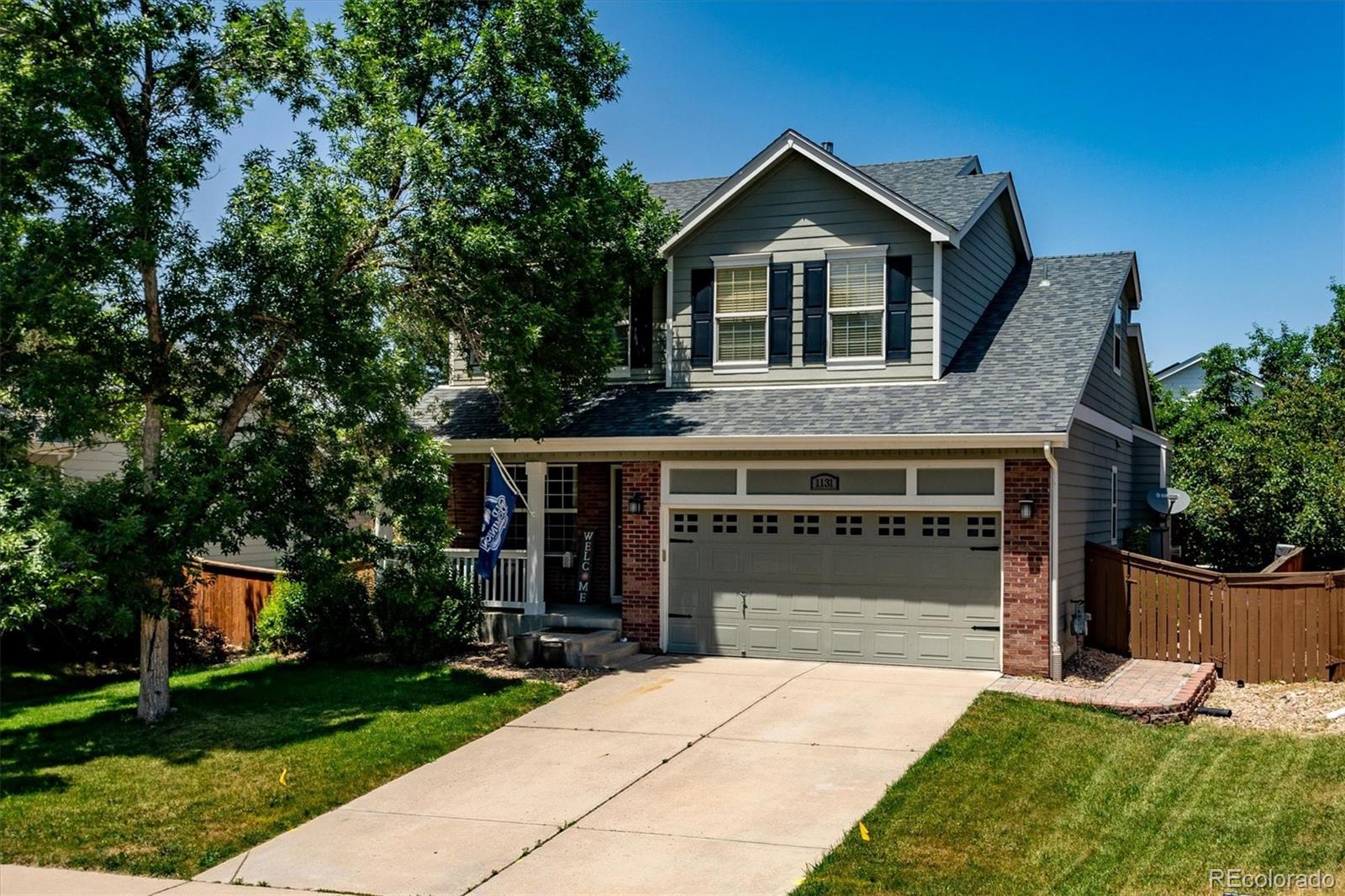 1131 Riddlewood Road Highlands Ranch, CO 80129 - Photo 1 of 1 a front view of a house with a yard and garage