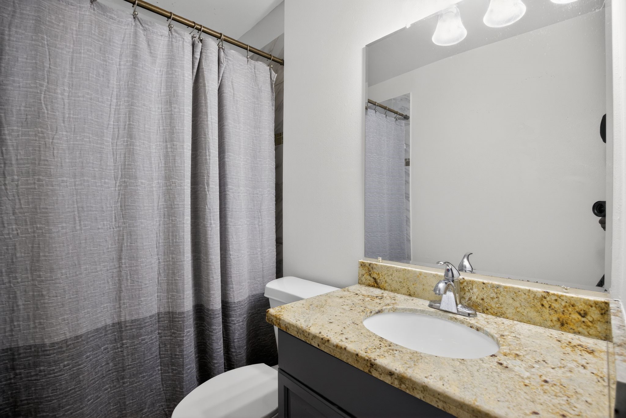 910 McLeary Street Houston, TX 77020 - Photo 15 of 23 a bathroom with a granite countertop sink and a mirror