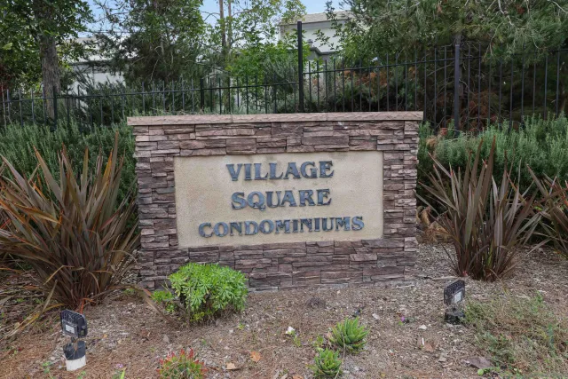 a sign of golf club on a stone wall