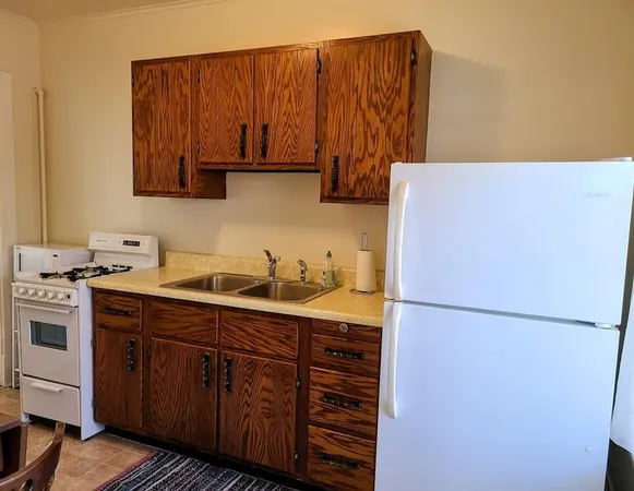 a kitchen with a sink and a refrigerator