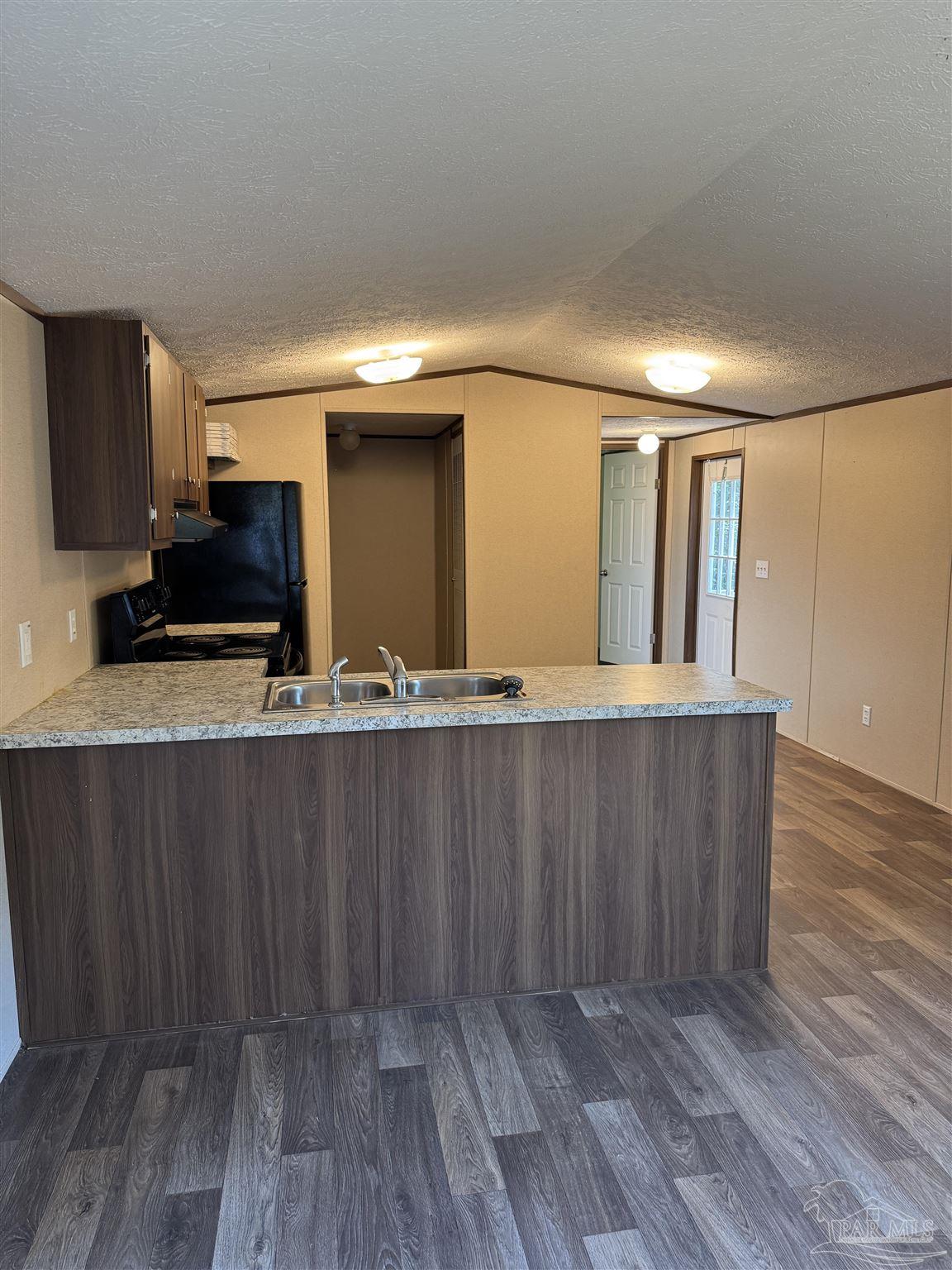 5049 Bent Tree Road Milton, FL 32583 - Photo 13 of 34 a view of kitchen with wooden floor and electronic appliances