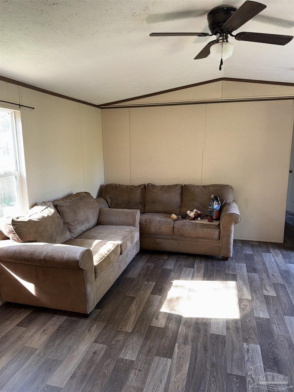 5049 Bent Tree Road Milton, FL 32583 - Photo 18 of 34 a living room with furniture and a hard wood floor