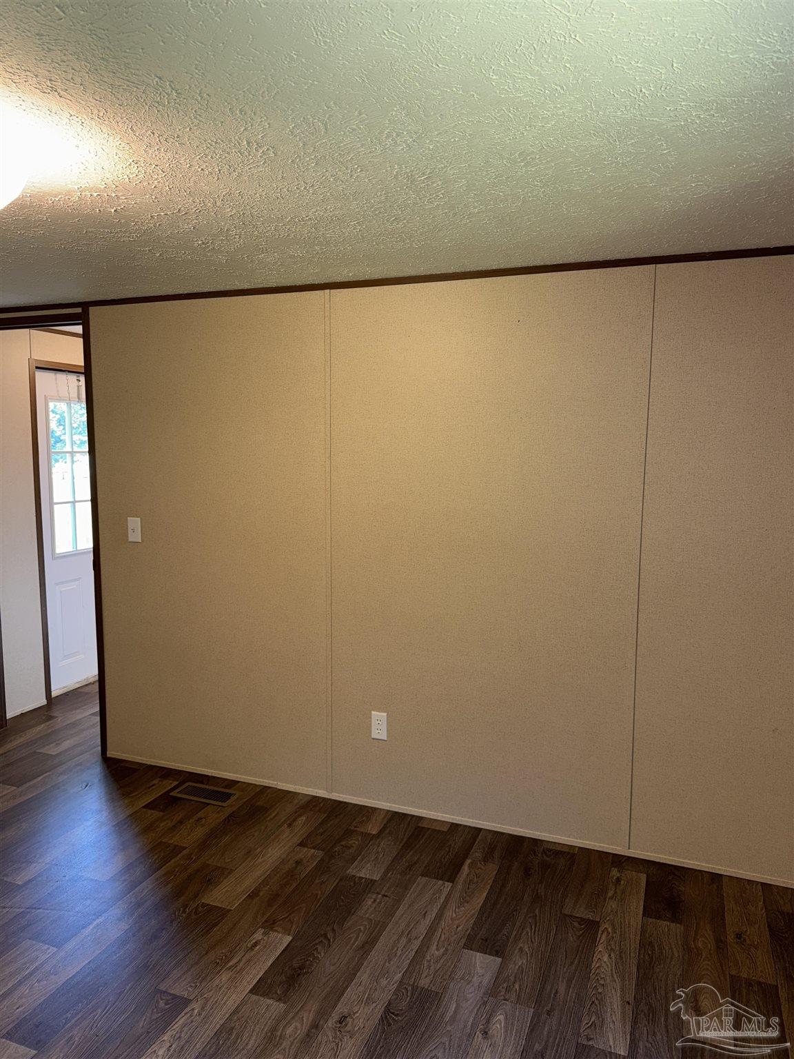 5049 Bent Tree Road Milton, FL 32583 - Photo 20 of 34 an empty room with wooden floor and windows