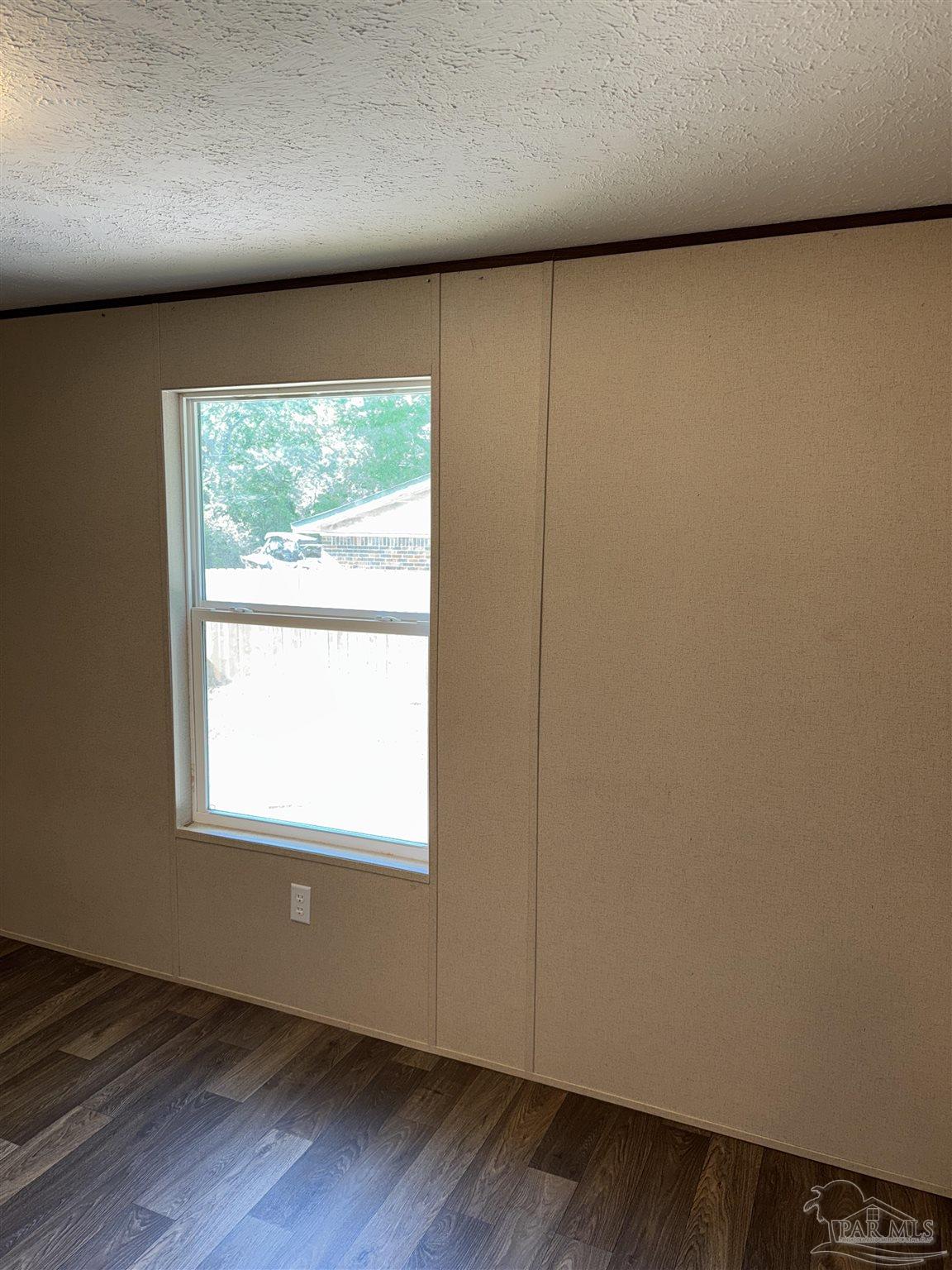 5049 Bent Tree Road Milton, FL 32583 - Photo 21 of 34 an empty room with wooden floor and windows