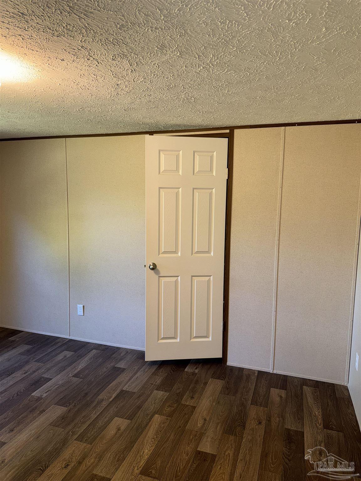 5049 Bent Tree Road Milton, FL 32583 - Photo 23 of 34 a view of an empty room with wooden floor