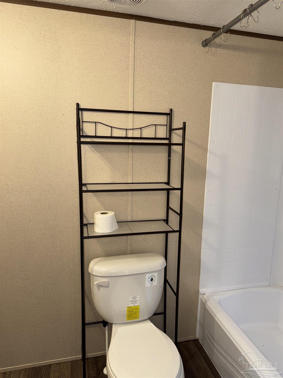 5049 Bent Tree Road Milton, FL 32583 - Photo 27 of 34 a bathroom with a toilet and a shower