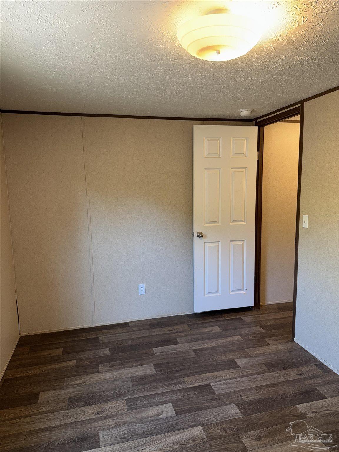 5049 Bent Tree Road Milton, FL 32583 - Photo 28 of 34 a view of an empty room with wooden floor and a window