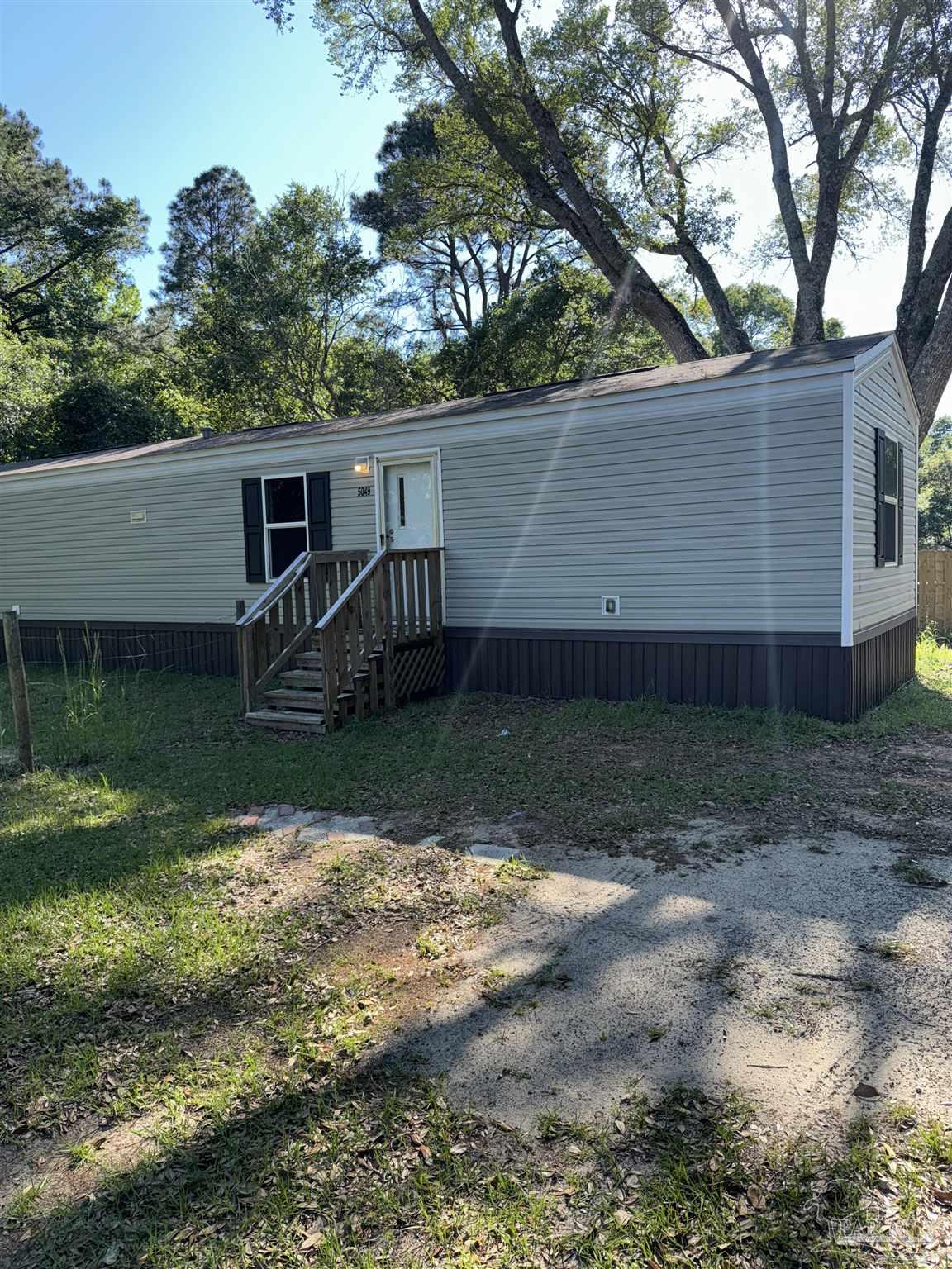 5049 Bent Tree Road Milton, FL 32583 - Photo 3 of 34 a view of a house with backyard and trees