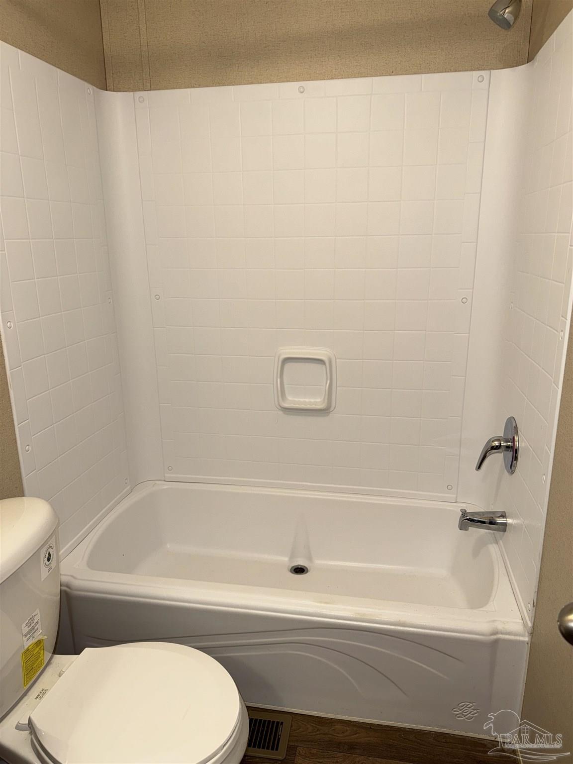 5049 Bent Tree Road Milton, FL 32583 - Photo 32 of 34 a bathroom with a toilet and a bathtub