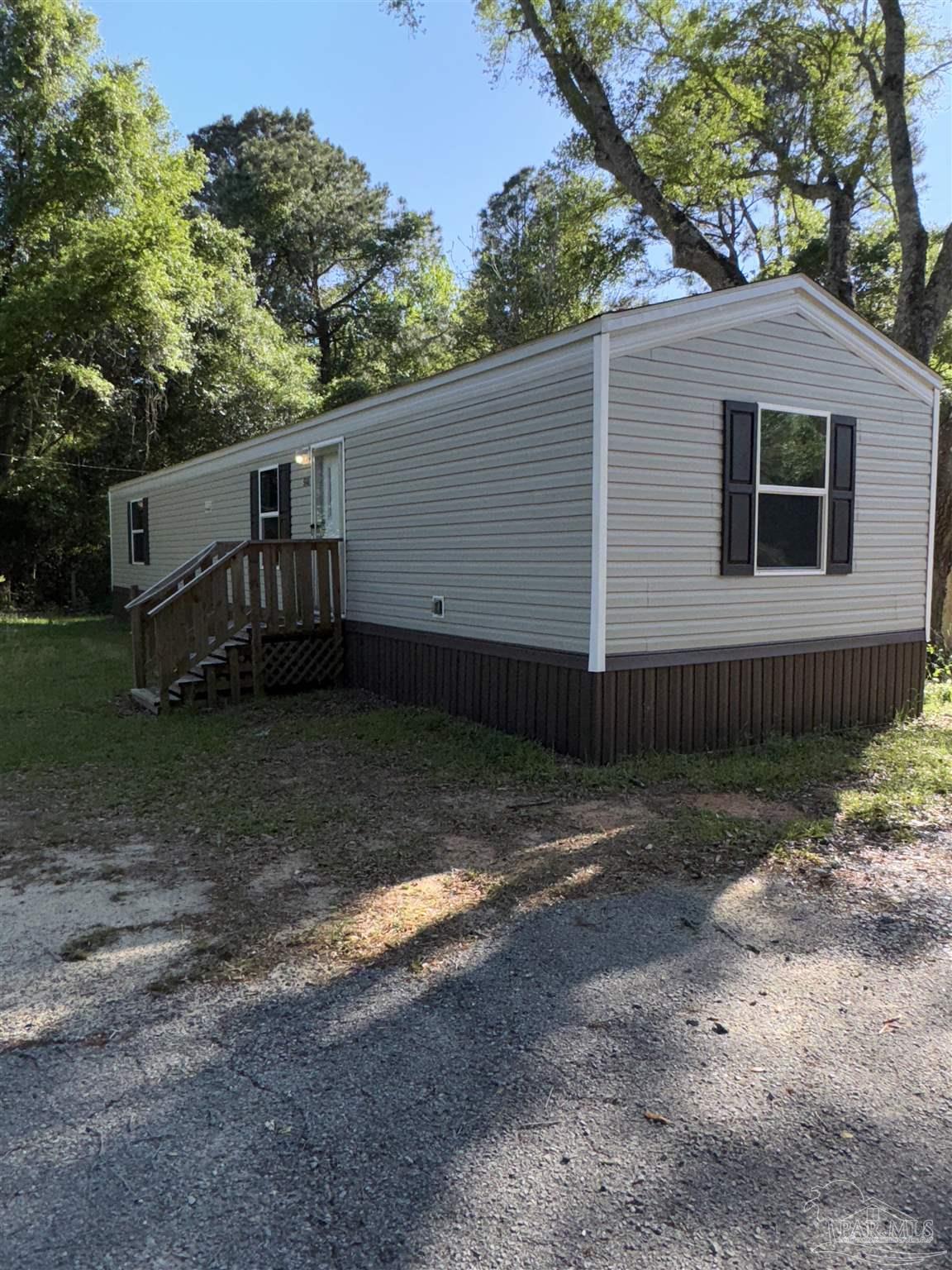 5049 Bent Tree Road Milton, FL 32583 - Photo 6 of 34 a view of a house with a yard