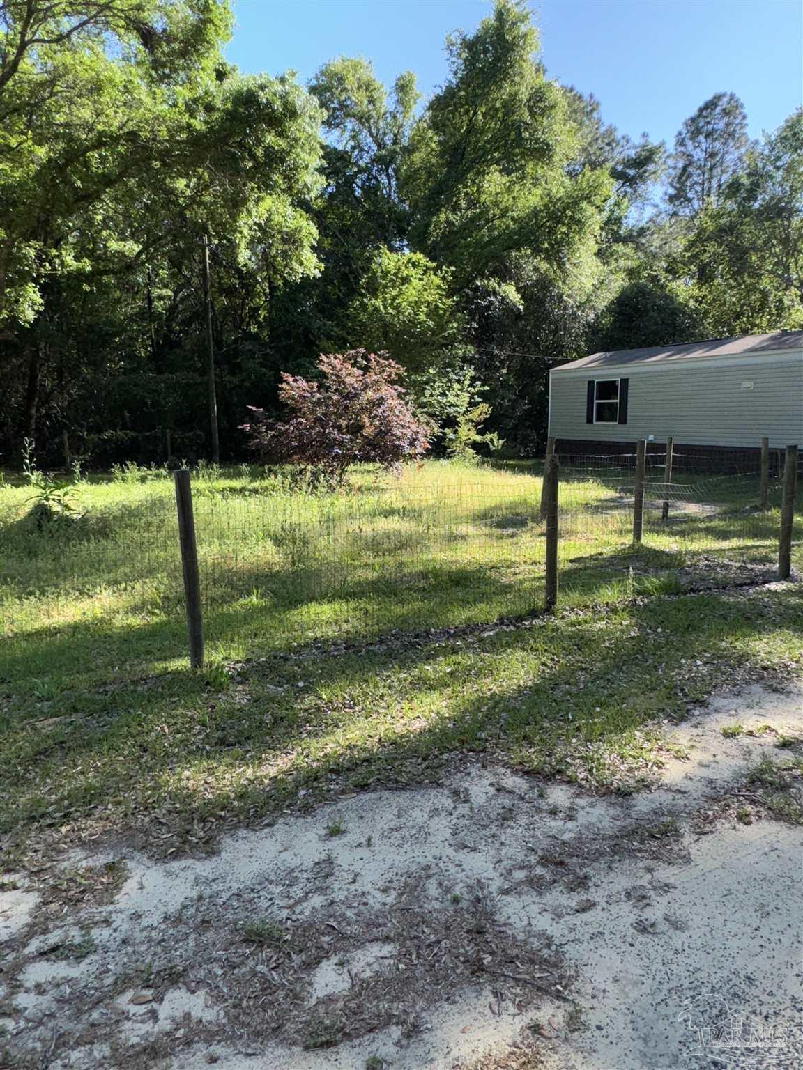 5049 Bent Tree Road Milton, FL 32583 - Photo 8 of 34 a view of a yard with a tree