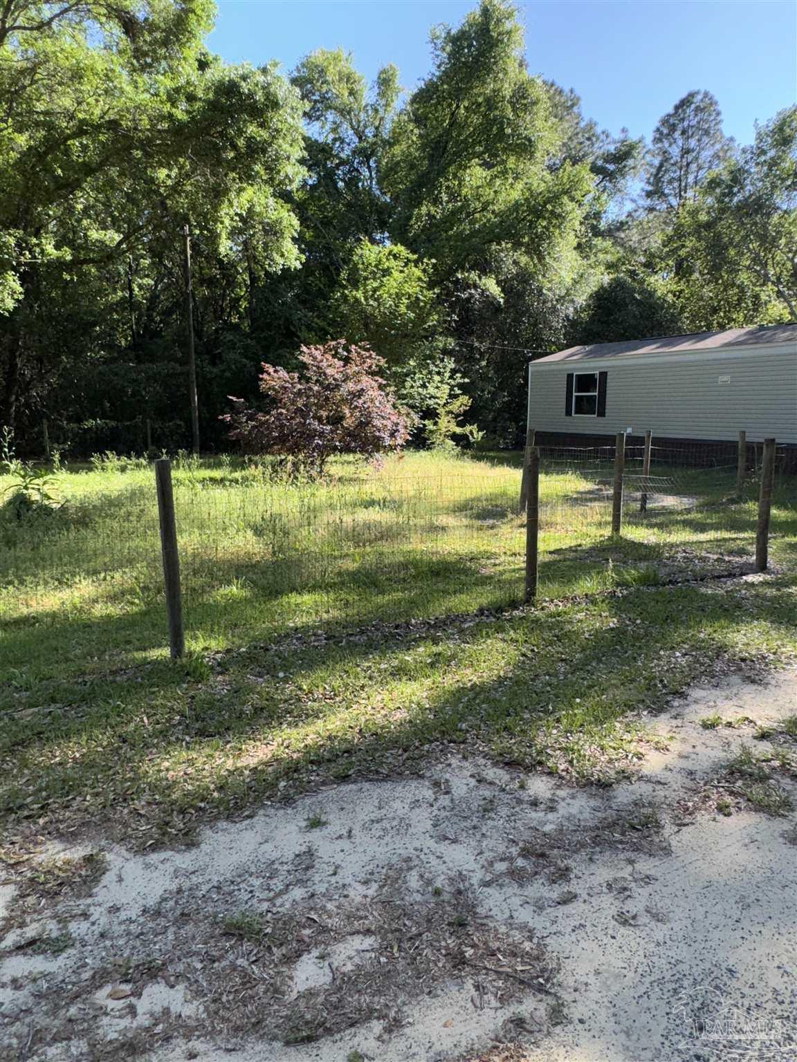 5049 Bent Tree Road Milton, FL 32583 - Photo 9 of 34 a view of a yard with a tree
