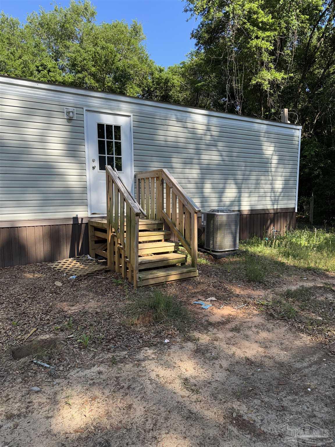 5049 Bent Tree Road Milton, FL 32583 - Photo 10 of 34 a view of house with backyard and seating area