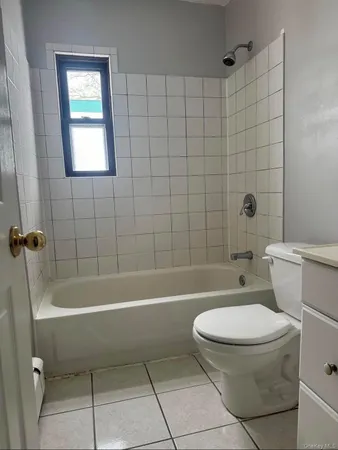 a bathroom with a toilet and a bath tub