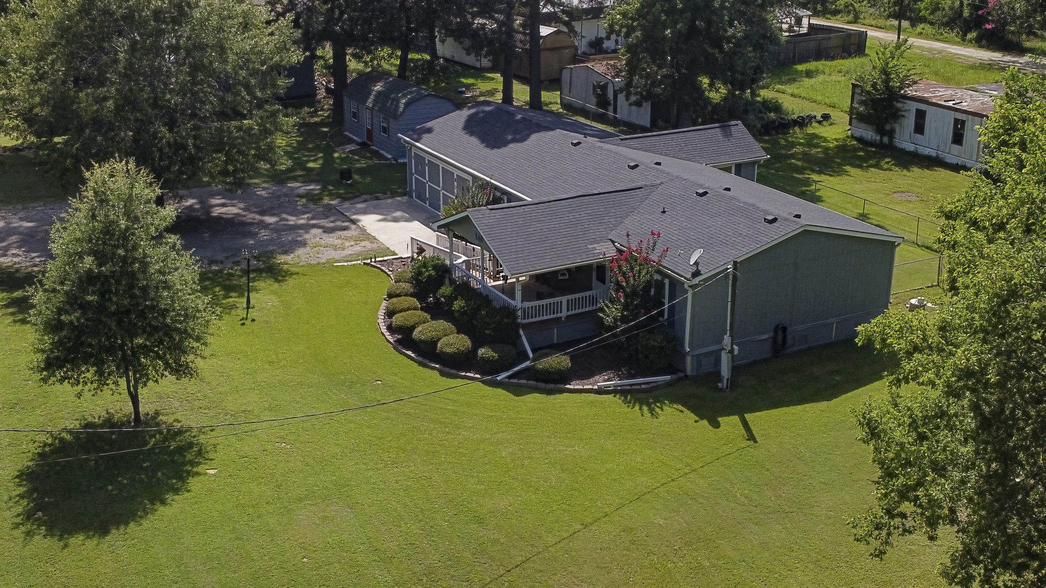 an aerial view of a house with a garden and swimming pool