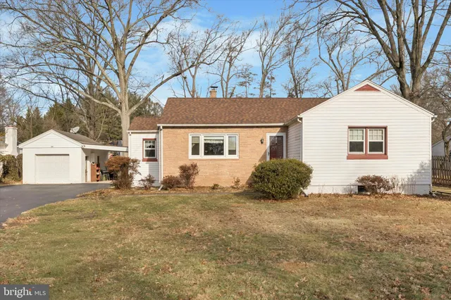 a view of a yard with a house and a tree