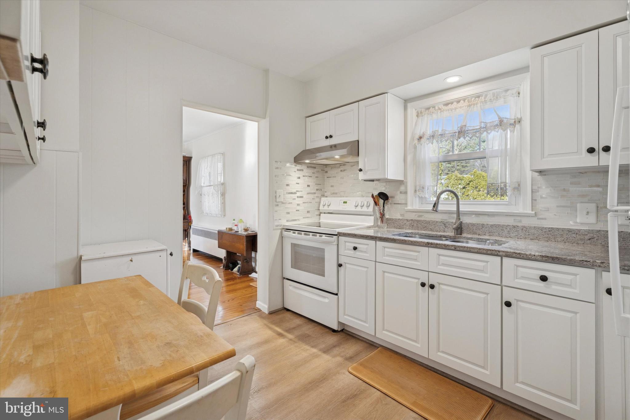 507 Park Road Spring City, PA 19475 - Photo 5 of 15 a kitchen with granite countertop white cabinets and white appliances
