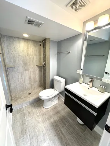 a bathroom with a sink toilet and shower