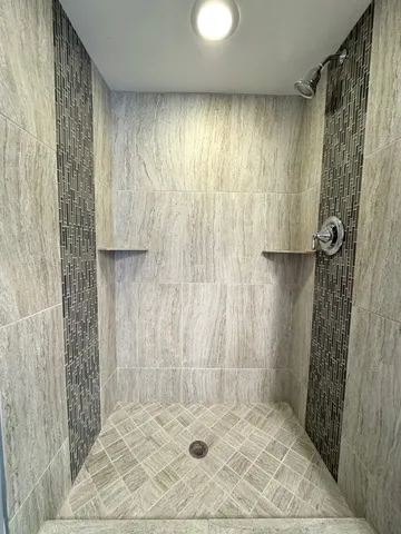 a bathroom with a shower and a tub