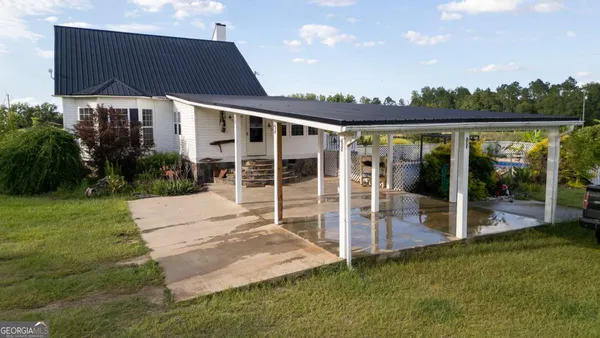 a view of an house with backyard space and balcony