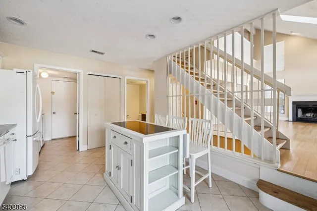 a view of a hallway with kitchen and entryway