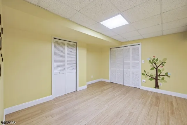 an empty room with wooden floor and plant