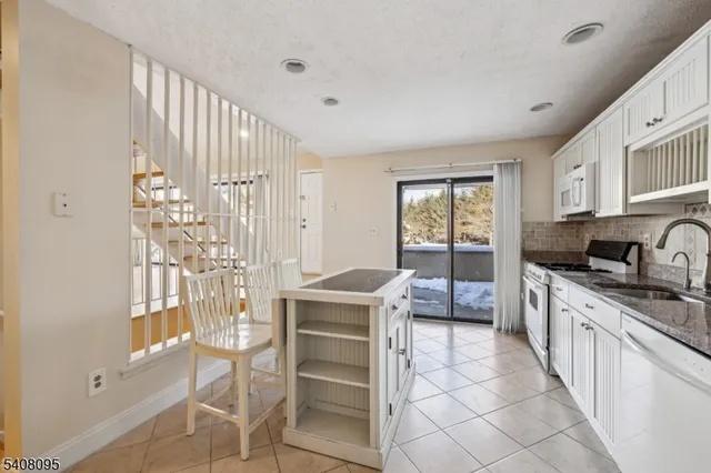 a kitchen with stainless steel appliances granite countertop a stove and cabinets