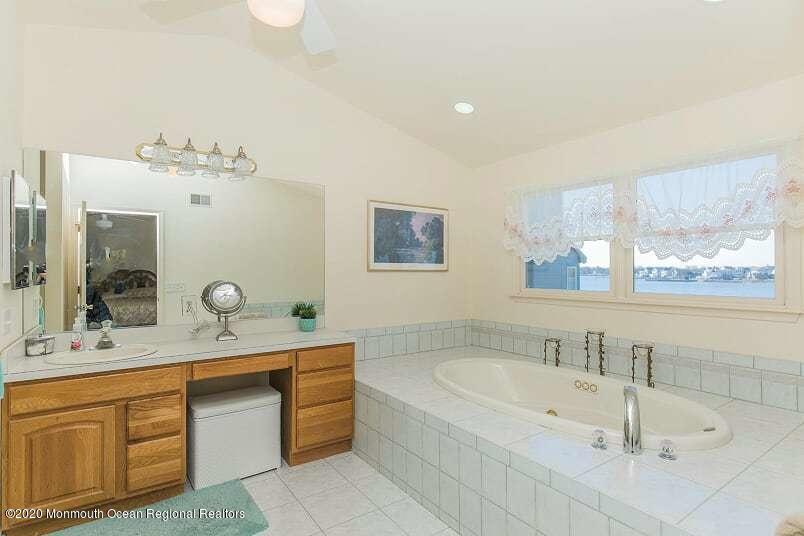 60 Seagoin Road Brick, NJ 08723 - Photo 35 of 53 a bathroom with a bathtub a double vanity sink and mirror