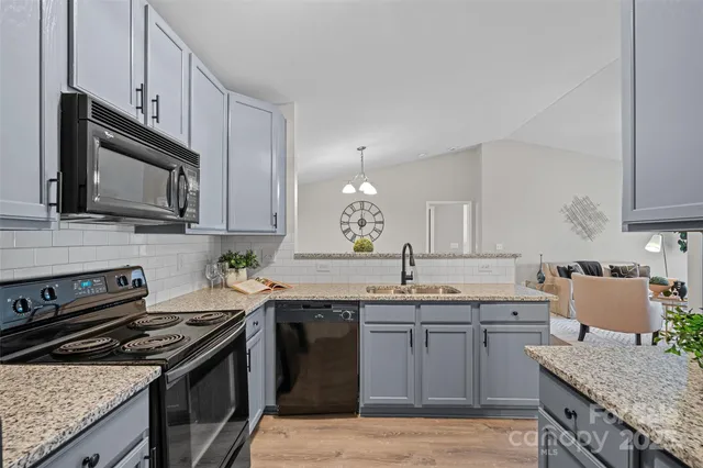 a kitchen with a sink stove and microwave