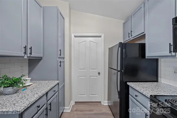 a kitchen with stainless steel appliances granite countertop a refrigerator and a sink