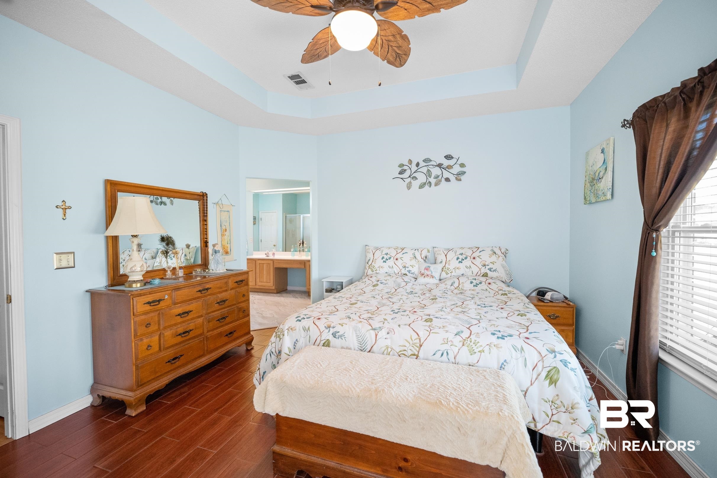 22355 East County Road 12 Foley, AL 36535 - Photo 29 of 54 Bedroom featuring a raised ceiling, wood tiled floors, ensuite bath, and a ceiling fan