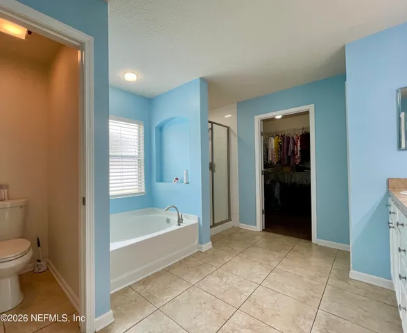 a bathroom with a tub and a shower