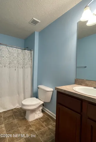 a bathroom with a sink toilet and a mirror