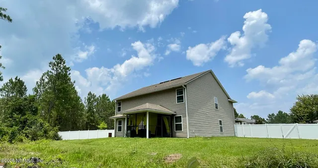 a view of a house with yard and a garden