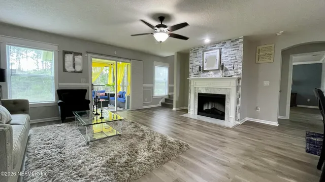 a living room with furniture a fireplace and a table
