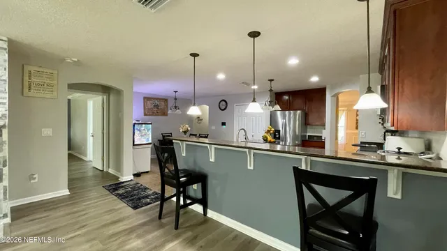 a kitchen with a sink a counter space appliances and cabinets