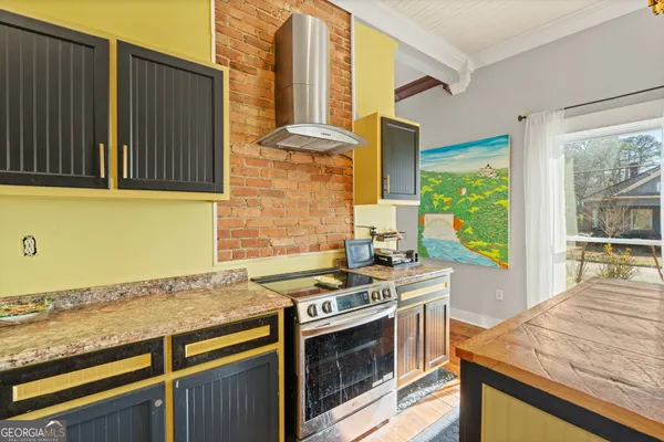 a kitchen with stainless steel appliances granite countertop a stove and a microwave