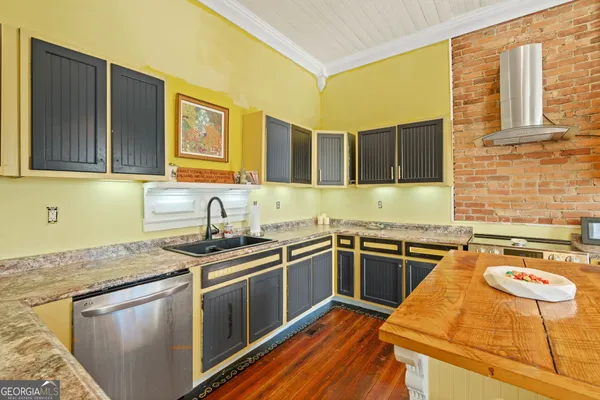 a kitchen with stainless steel appliances granite countertop a sink stove and cabinets