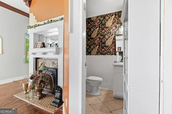 a bathroom with a toilet a sink and a mirror