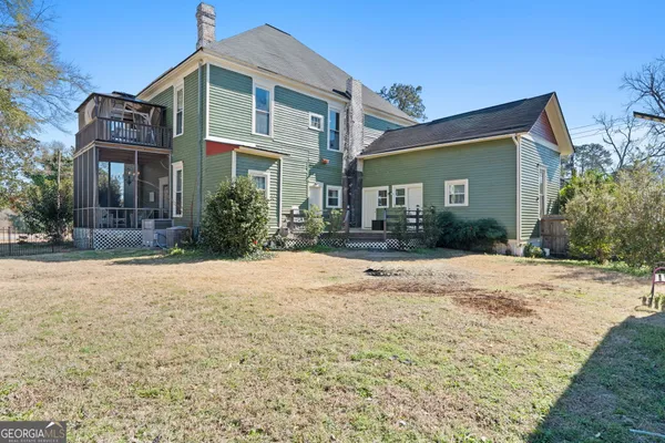 a front view of a house with a yard and outdoor seating