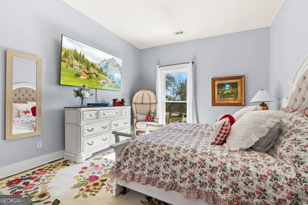a bedroom with a bed and a dresser in it