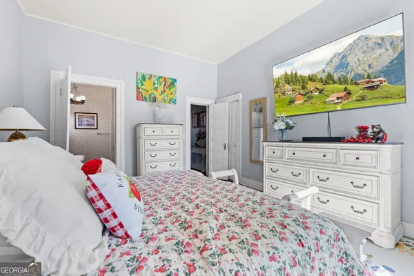 a bedroom with a bed and dresser